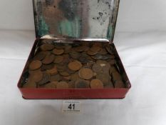 A tin of coins including old pennies