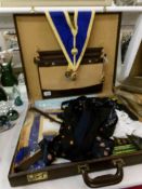 A case of Masonic items including Jewels, apron, ties,