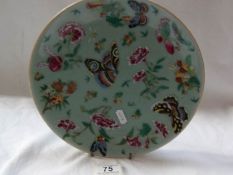 A Chinese Famille rose plate with celadon glaze,