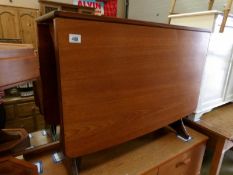 A teak drop leaf dining table