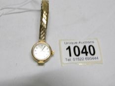 A Rotary gold ladies 17 jewel wrist watch on yellow metal bracelet