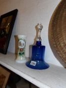 A blue glass bell and an opaque glass hand painted vase