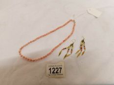 A coral bead necklace and earrings