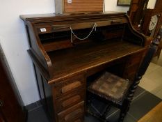 An oak double pedestal roll top desk