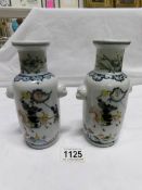 A pair of 17cm 19th century Chinese vases depicting horse men (one has chip to base)