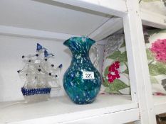 A blue mottled glass jug and a glass ship