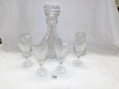 A heavy cut glass decanter and set of 6 cut glass wine glasses