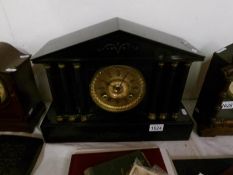 A black marble Paladian style mantel clock