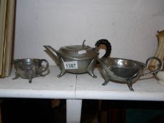 An Arts and Crafts hammered pewter 3 piece tea service