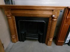 A pine fire surround with inset solid fuel fire place