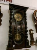 A Victorian wall clock with figure of eight door