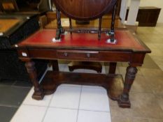 A Victorian writing table with leather inset top