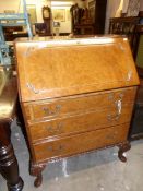 A 1930's walnut veneered bureau