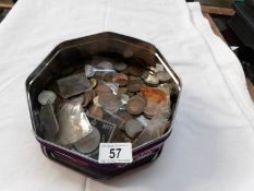 A tin of mixed UK and foreign coins