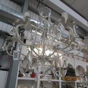 A 6 light metal and glass chandelier