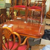 A mahogany extending dining table and 8 chairs