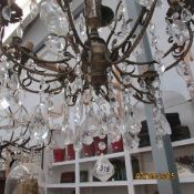 An 8 light metal and glass chandelier