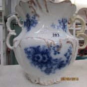 A large blue and white gilded lidded pot,