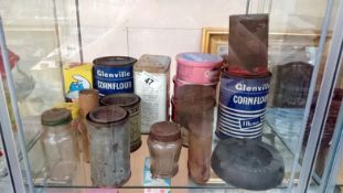 A shelf of advertising tins etc.