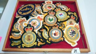 A display case of RAF cloth squadron badges