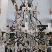 A 10 light metal and glass chandelier