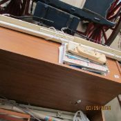 A knitting machine in fitted cabinet with stool