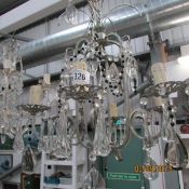 A 6 light metal and glass chandelier