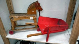 A child's tow along horse & a wheelbarrow