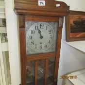 An oak cased wall clock