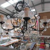 A 5 light metal and glass chandelier