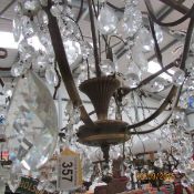 A 6 light metal and glass chandelier