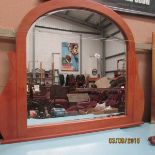 A domed top bevel edged over mantle mirror