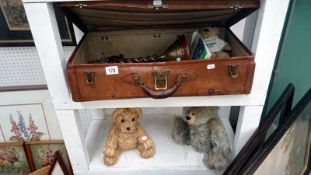 A leather suitcase and contents including brass companion set,