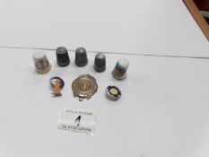 A tin containing 1950's Butlins badges, thimbles,