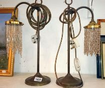 A pair of brass swan neck table lamps with beaded shades