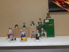 Approximately 9 Robert Harrup Doggie People figurines and a house,