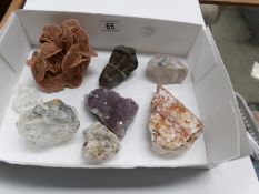 A box of assorted fossils and minerals including amethyst