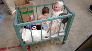 A doll's cot and dolls