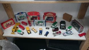 A quantity of boxed and unboxed die cast cars including Lledo, Corgi,