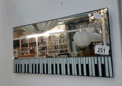 A mirror decorated with a piano keyboard