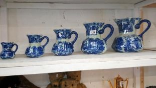 A set of 5 graduated blue and white Ironstone jugs