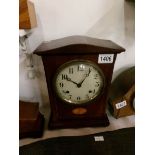 A mahogany inlaid mantel clock