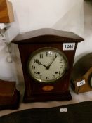 A mahogany inlaid mantel clock