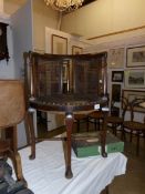 An Edwardian corner chair on Queen Anne style legs with bergere panels in the back