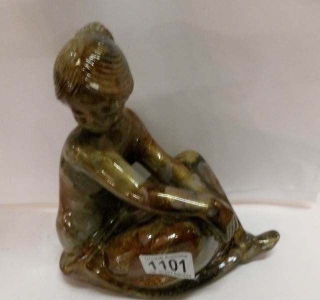 A figure of a seated girl