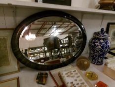 A framed oval bevel edged mirror