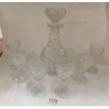 A cut glass decanter and 6 glasses
