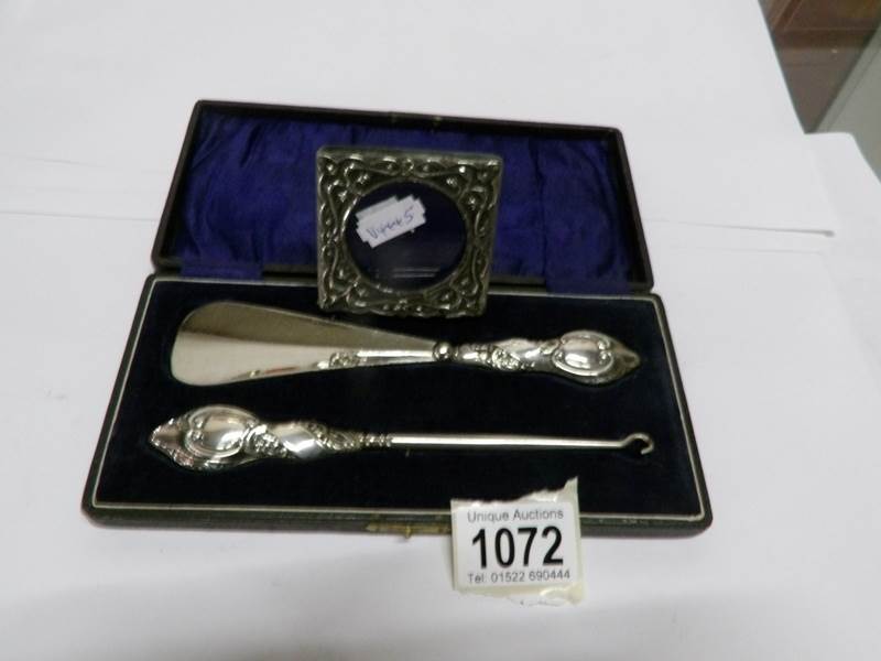 A cased silver handled shoe horn and button hook hallmarked Chester 1920's together with a small