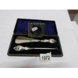 A cased silver handled shoe horn and button hook hallmarked Chester 1920's together with a small