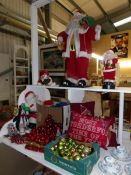 A large quantity of Christmas decorations including large and small Santa's, cushions,